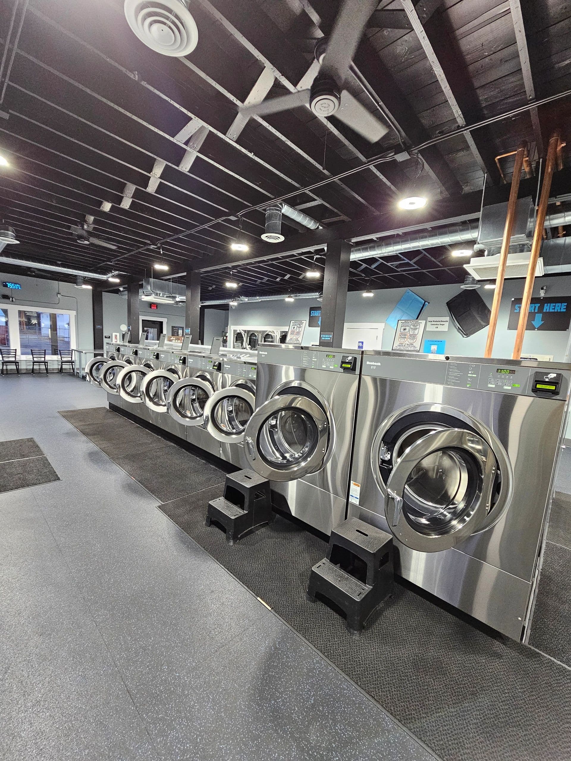 Inside 123 Laundry — Deer Park — modern stainless commercial laundry machines
